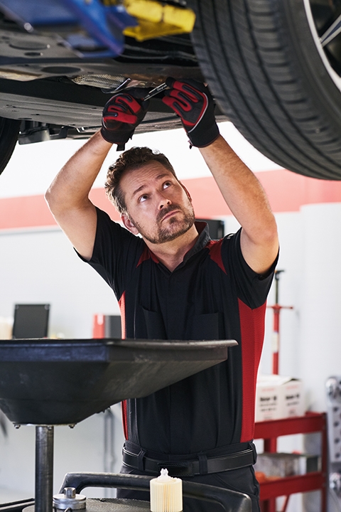 Mechanic performing oil change service