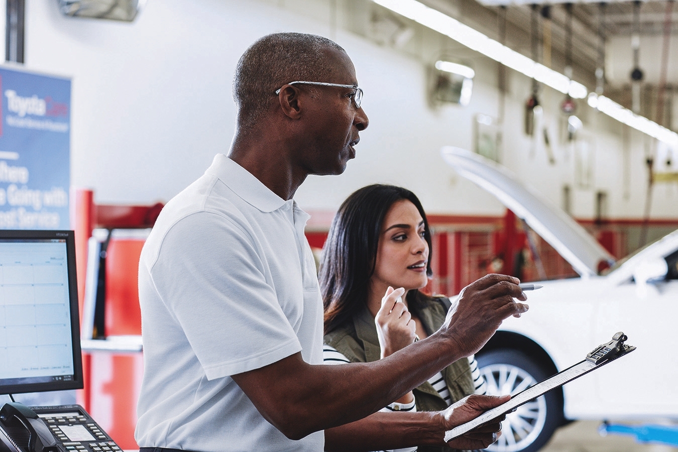 Service advisor going over vehicle details with customer