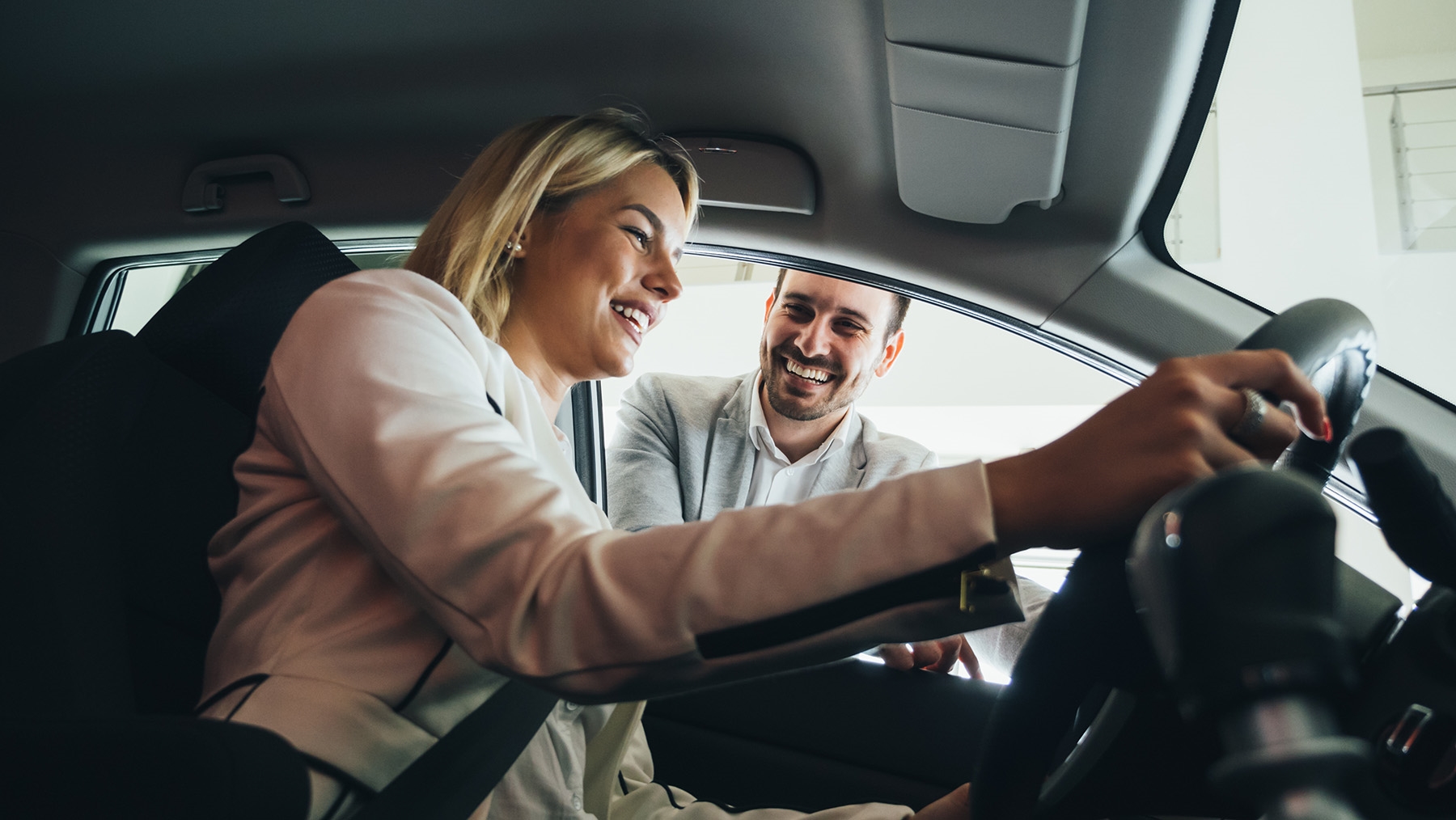 Couple sitting inside a pre-owned vehicle during test drive