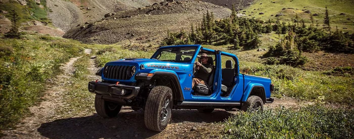A blue 2026 Jeep Gladiator off-roading