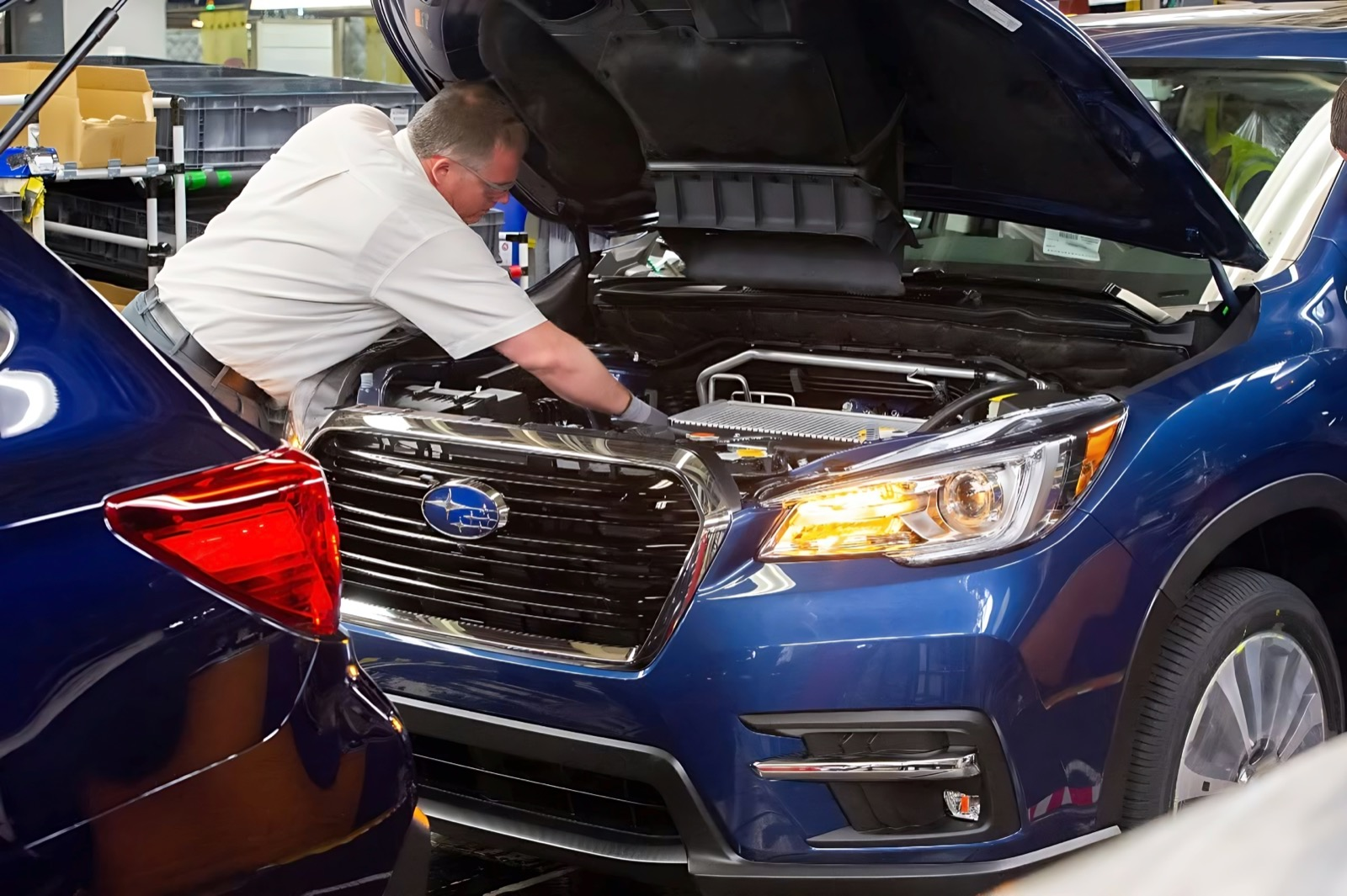 A Findlay Subaru Prescott technician working under the hood of a Subaru in the service shop during a scheduled maintenance visit.