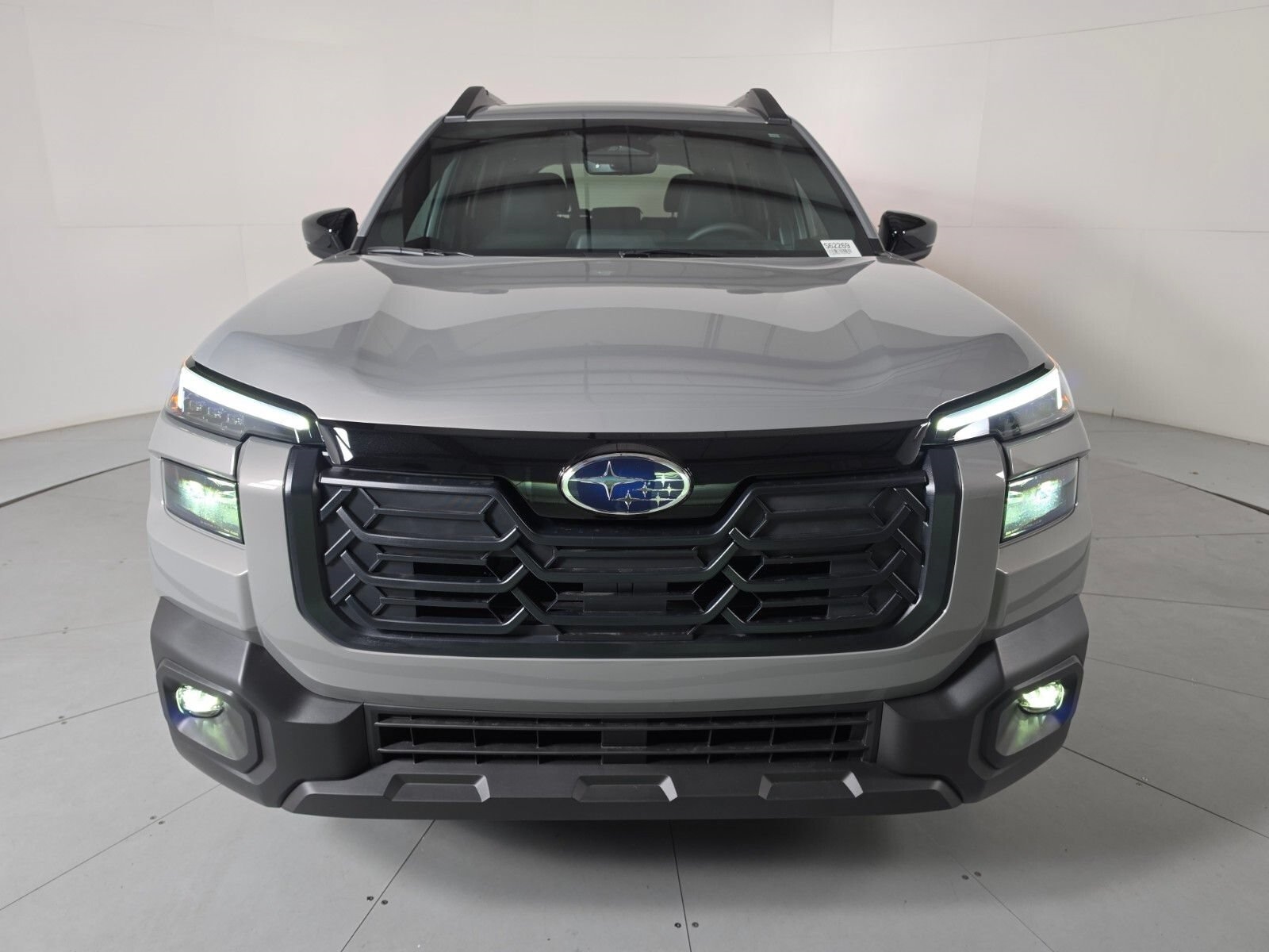 Front three-quarter view of a grey Subaru Outback in the studio