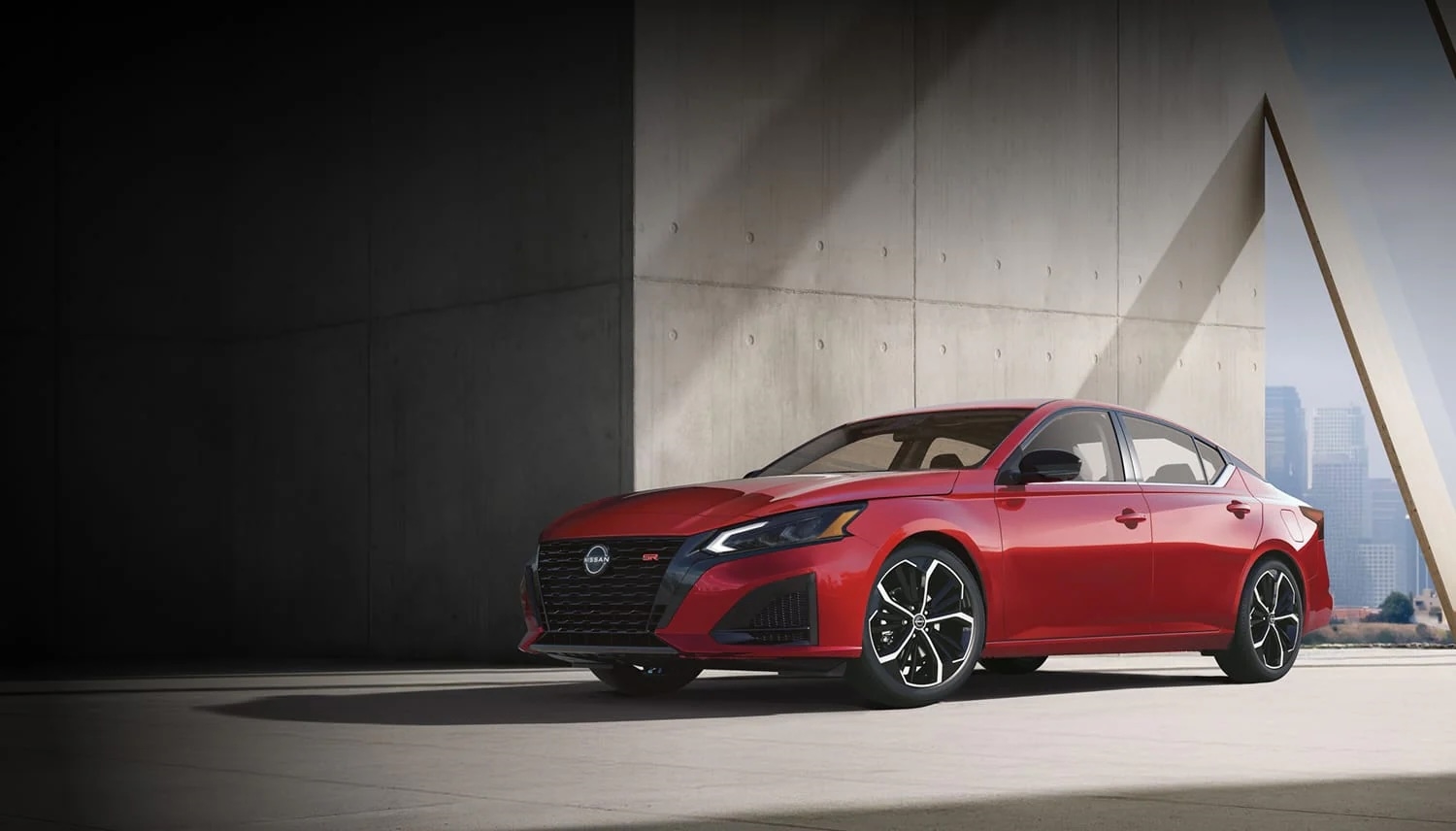 Red 2026 Nissan Altima in a front three-quarter view, parked beside a sunlit concrete building.