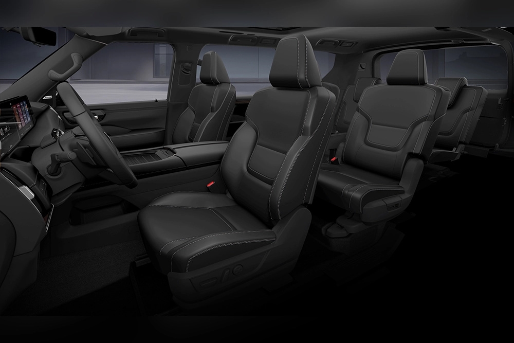 2027 Nissan Armada Dark Armor passenger cabin with three rows of black seats.