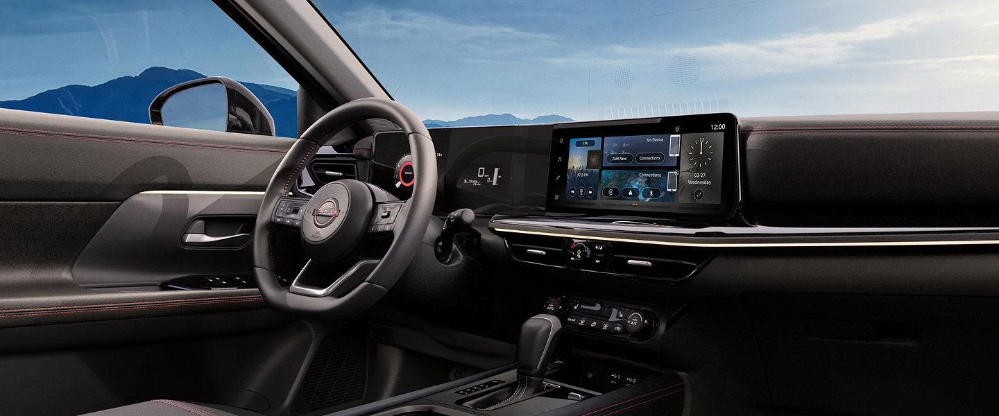 2027 Nissan Kicks Rock Creek driver’s seat, steering wheel and dashboard.