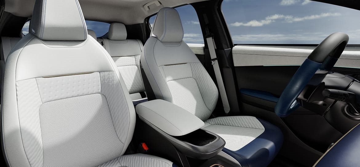 Light-colored front seats and center console inside the 2026 Nissan LEAF.
