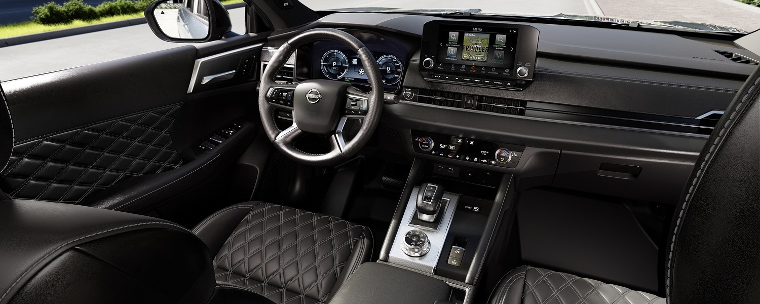 2026 Nissan Rogue Plug-in Hybrid cockpit with steering wheel, dashboard, touchscreen and center console.
