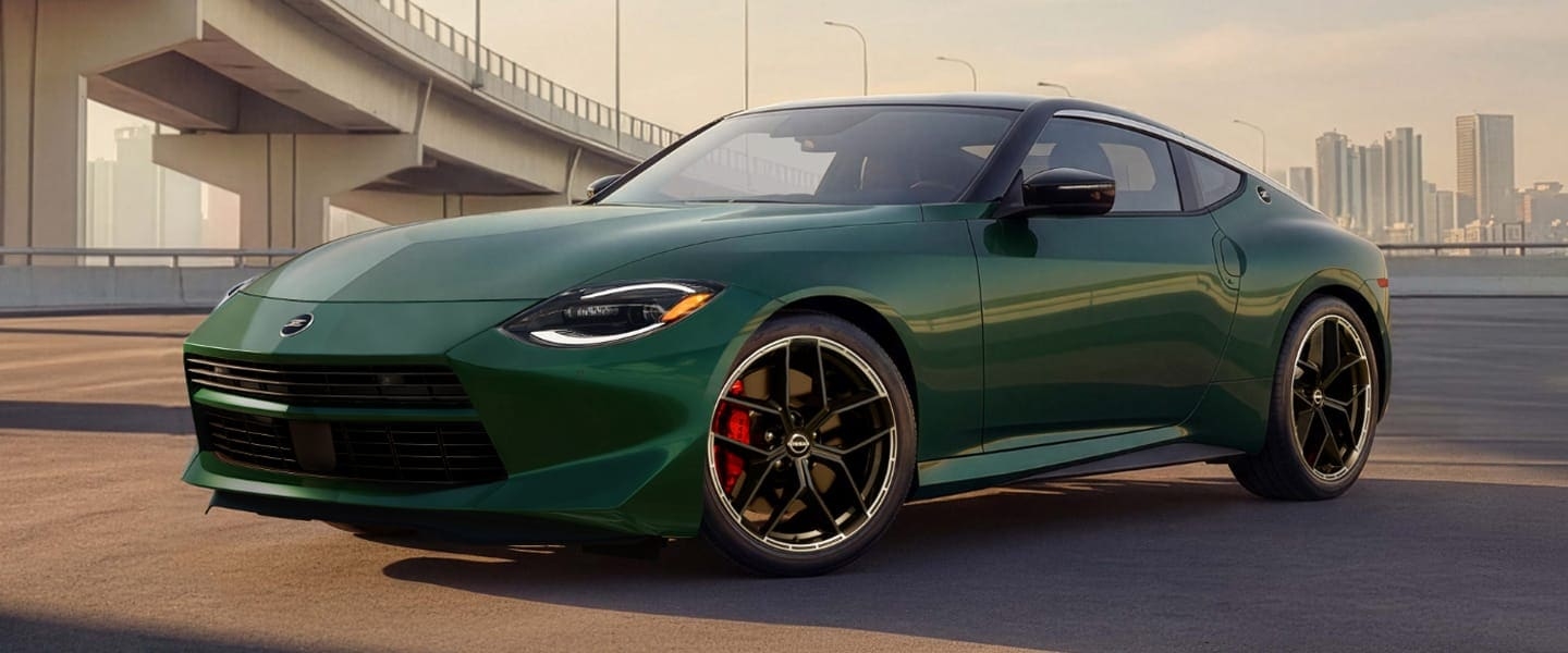 Green 2027 Nissan Z Performance in a front three-quarter view on a city street.