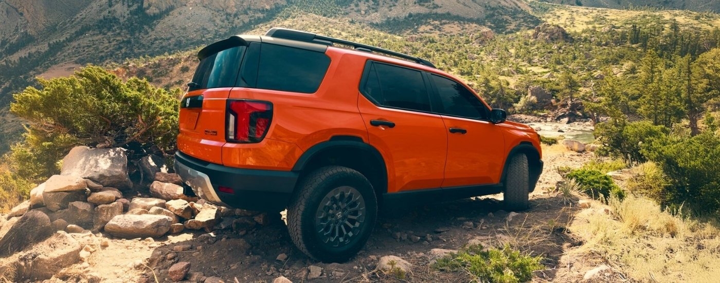 Orange 2026 Honda Passport off-roading