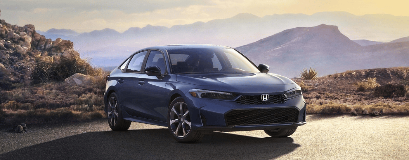 Grey 2026 Honda Civic parked at an angle in front of a canyon