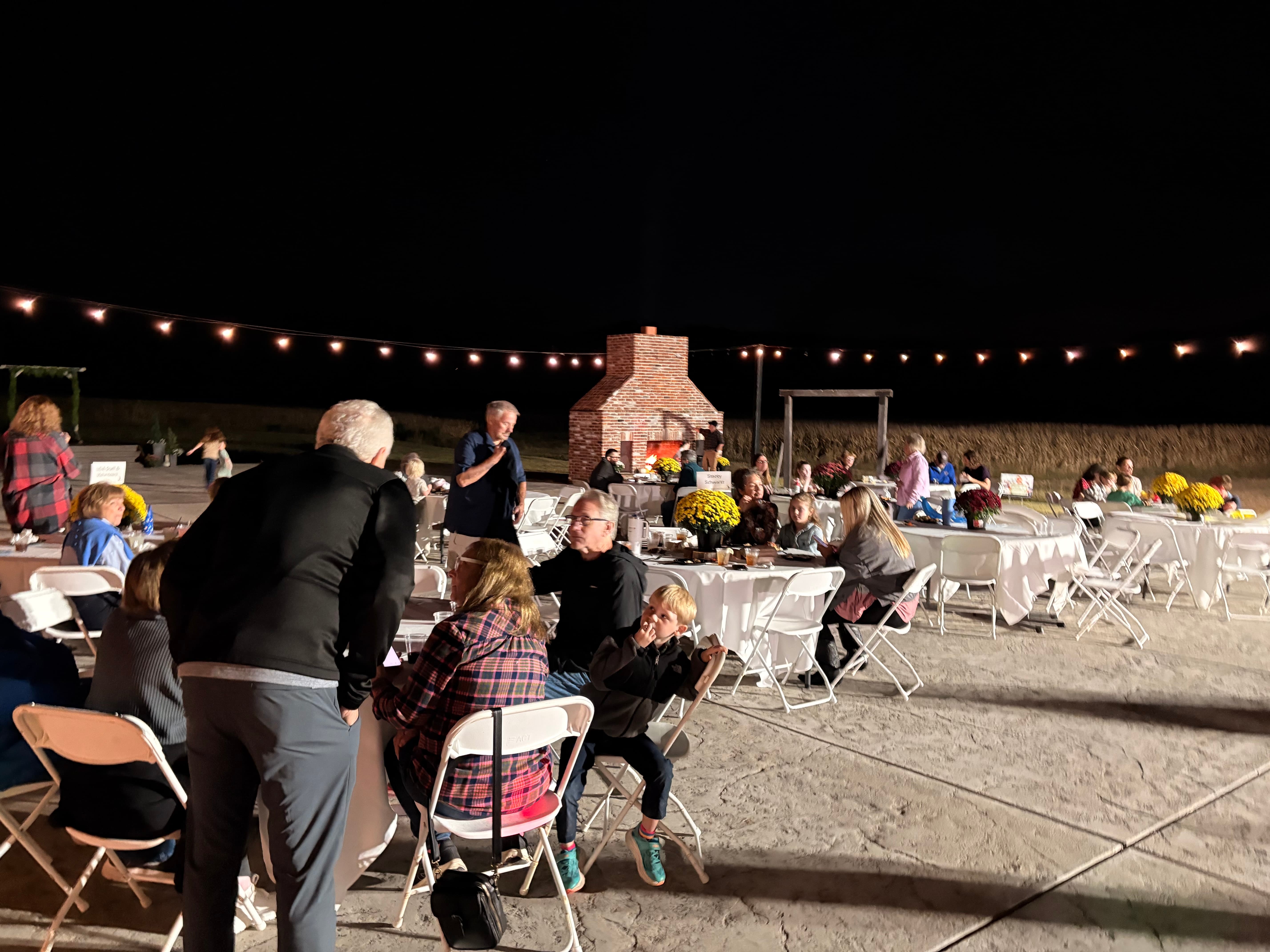 Guests gathered under string lights at the St. Louis LDA fall gathering