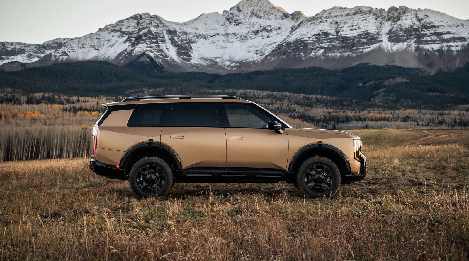 2027 Kia Telluride X-Pro, rated to tow 5,000 lbs, parked below snowy mountain peaks