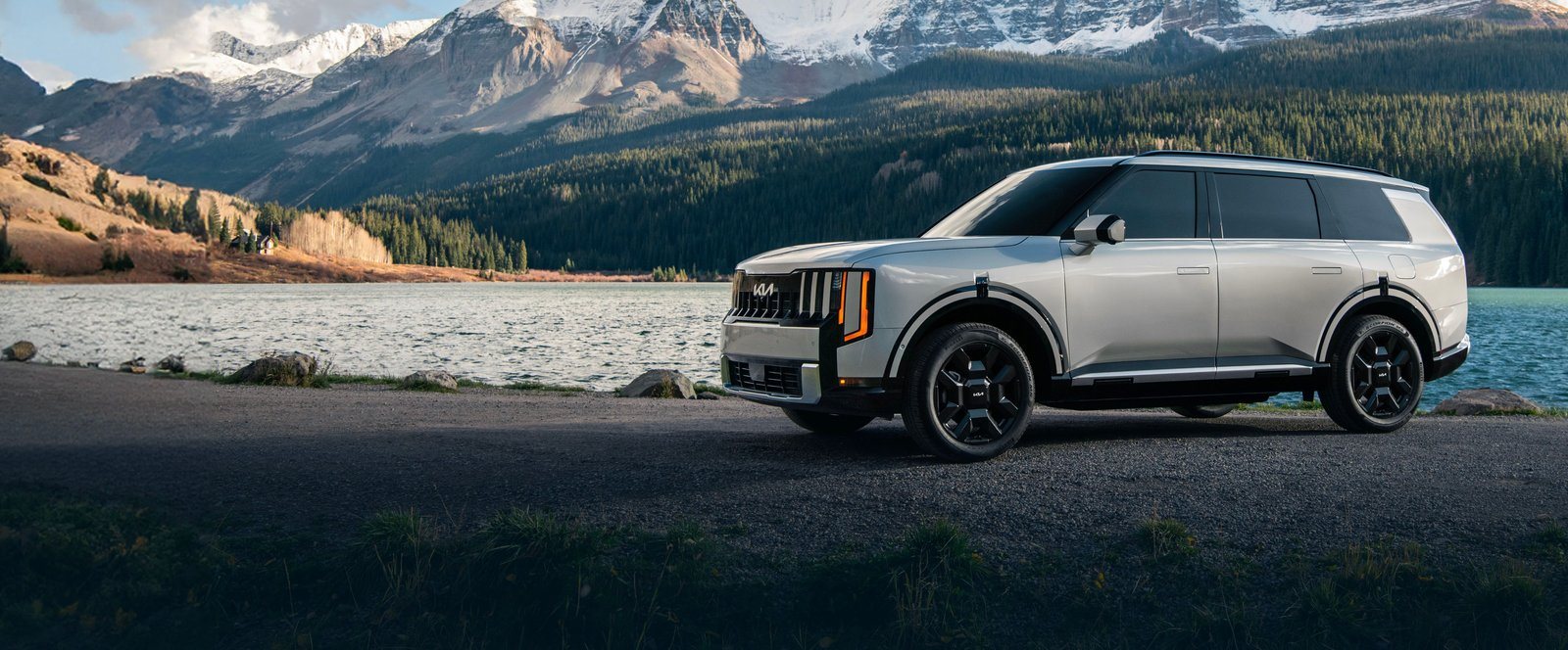 2027 Kia Telluride Hybrid parked beside a mountain lake in Colorado