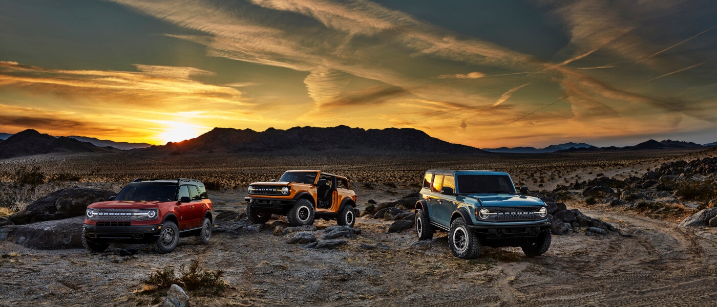 2026FordBroncoExteriorThreeParkedInDesertAtSunset