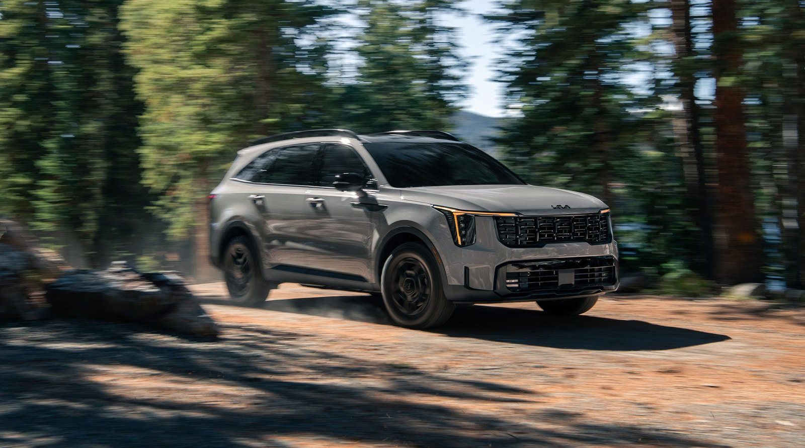 2027 Kia Sorento X-Pro driving on a forest dirt road