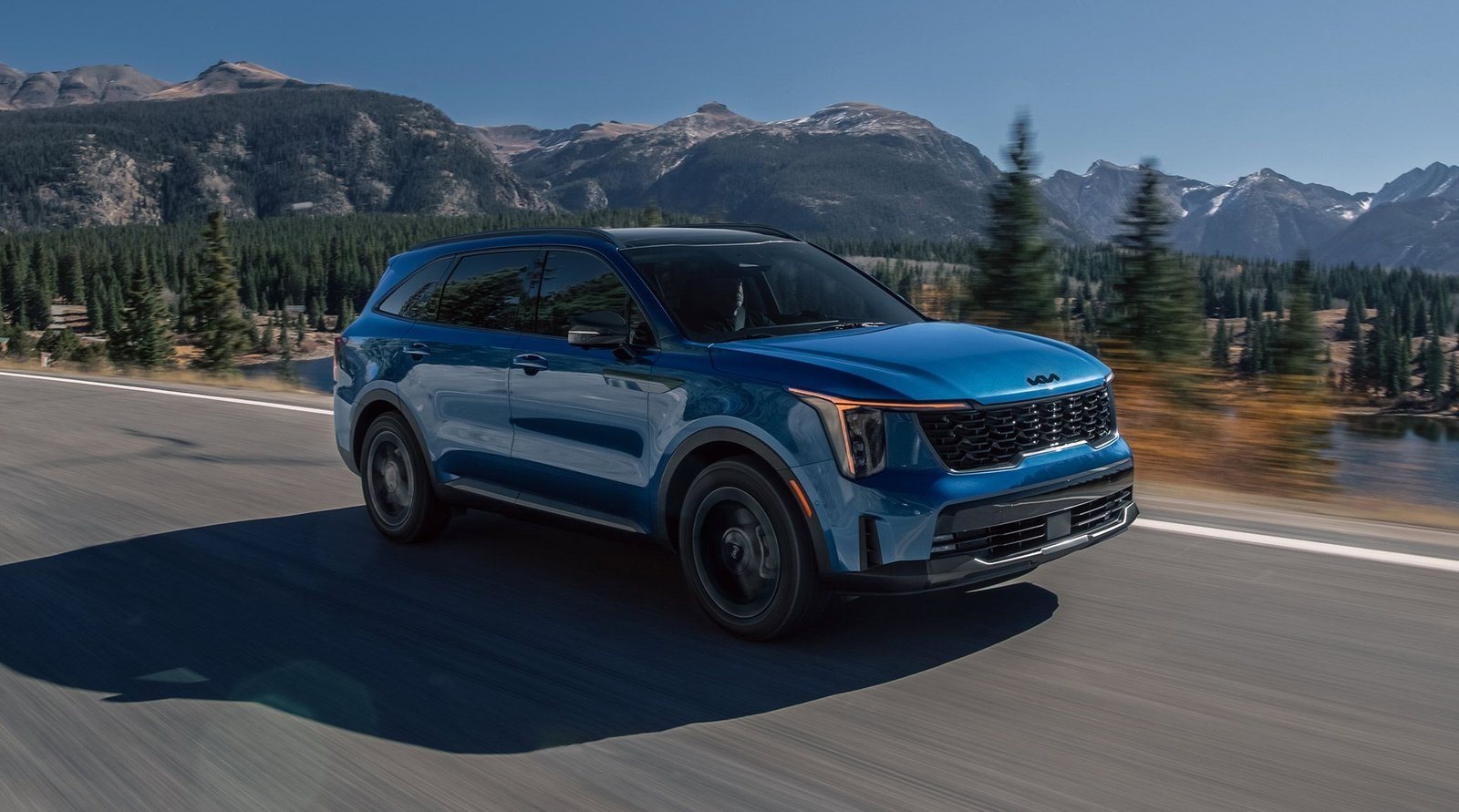 2027 Kia Sorento Hybrid in blue driving on a mountain highway