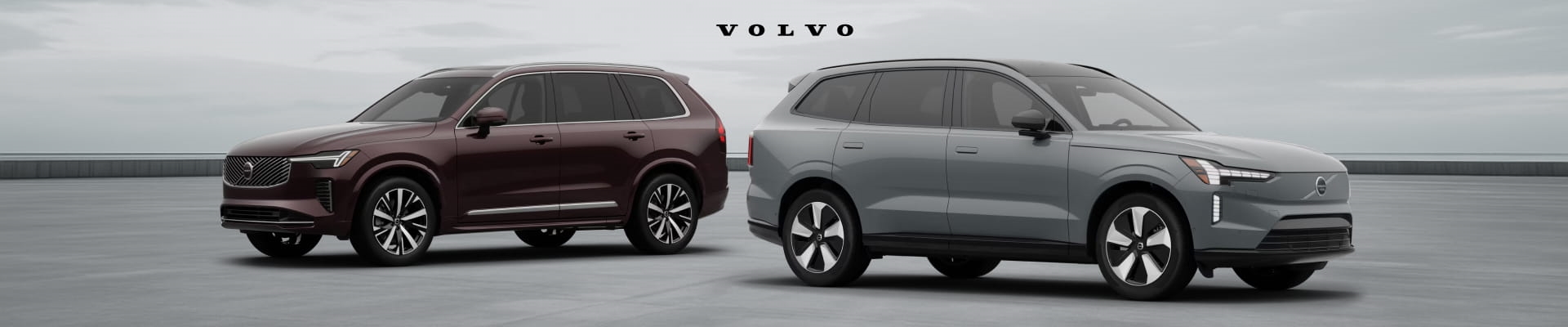 Volvo XC90 and gray Volvo EX90 SUVs parked side by side on a paved surface, showcasing their exterior designs, front grilles, and alloy wheels.