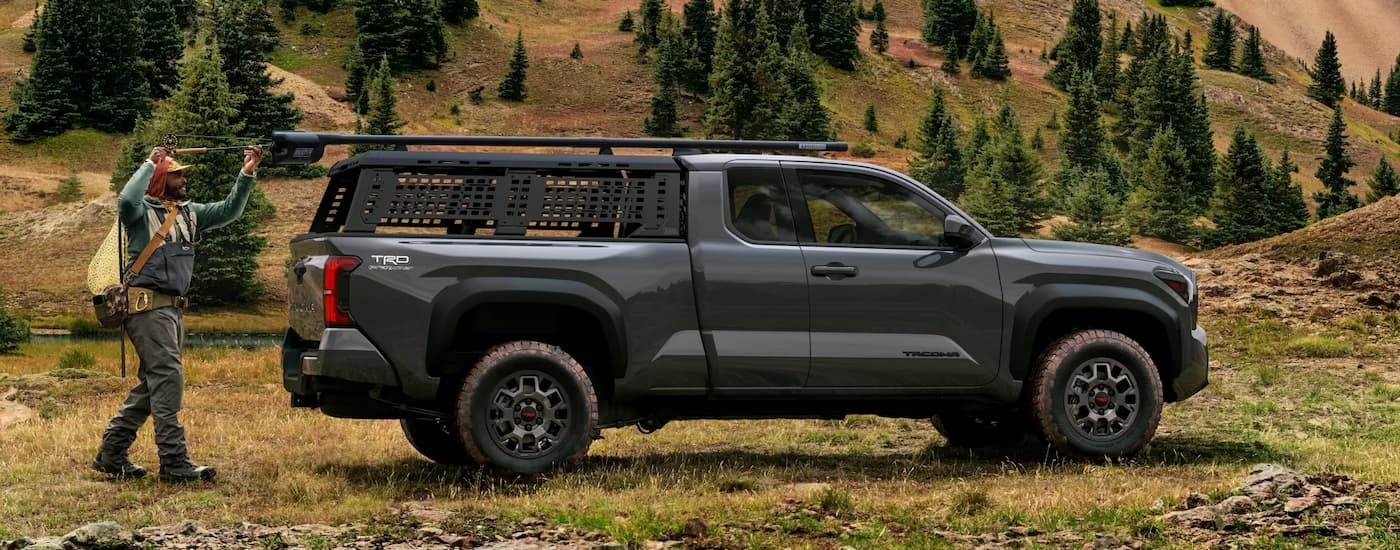 Side of a black 2026 Toyota Tacoma parked off-road.