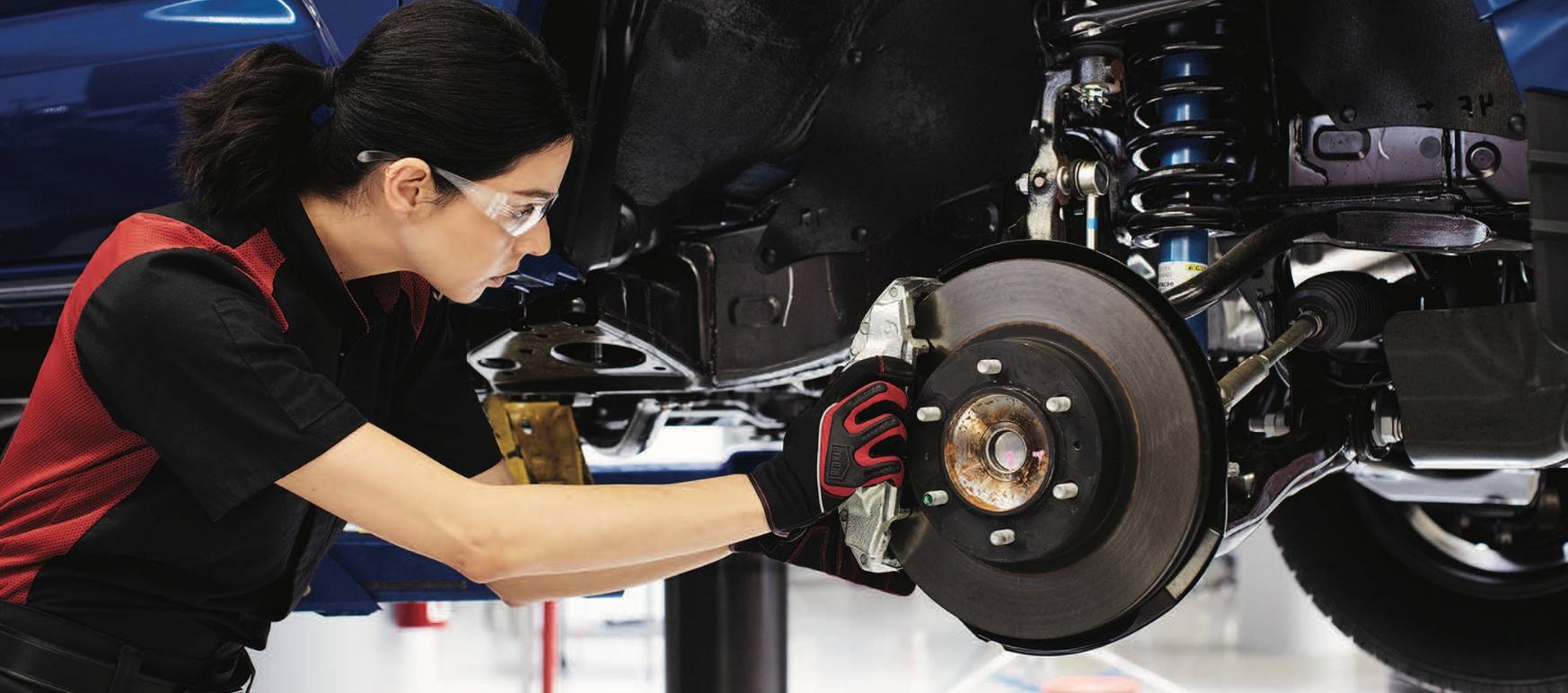 Female Toyota Service Technician working on brake repair at Toyota of Dartmouth