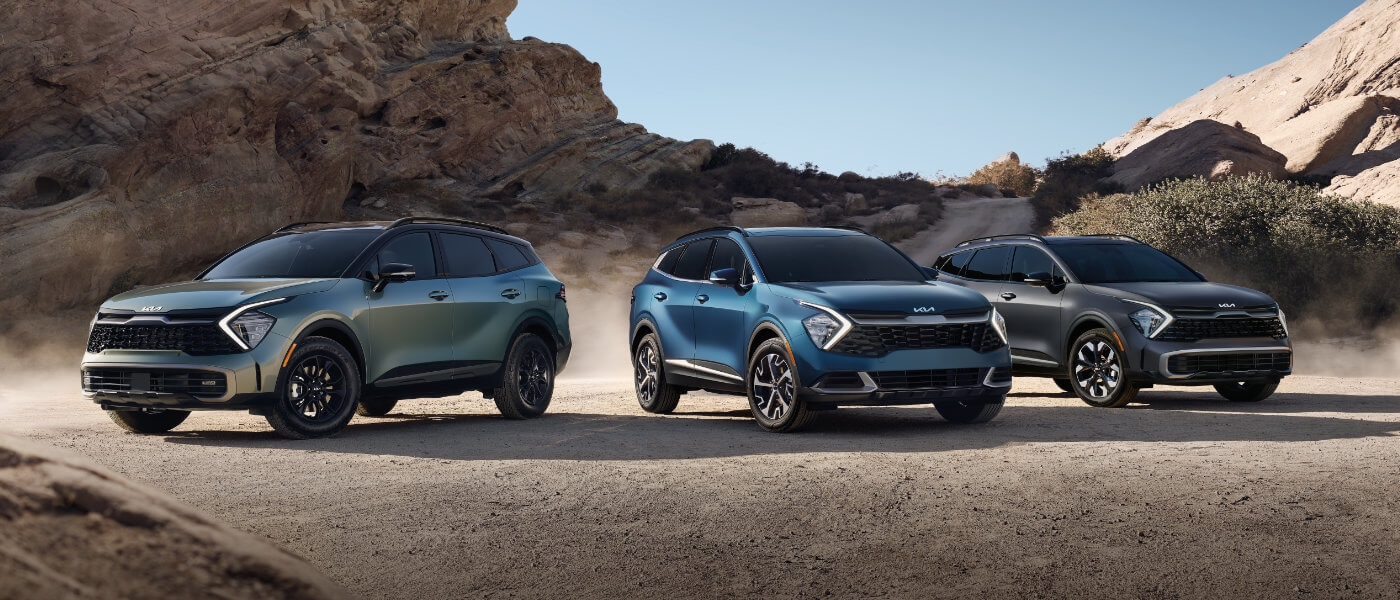 Three 2024 Kia Sportages parked in desert